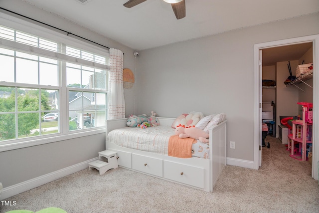 77 Redpine Ct, Clayton, NC 27520 - bedroom featuring a spacious closet, multiple windows, carpet floors, and baseboards