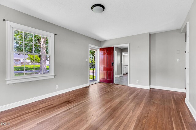 2719 Stratford Dr, Greensboro, NC 27408 - foyer with wood finished floors, plenty of natural light, and baseboards