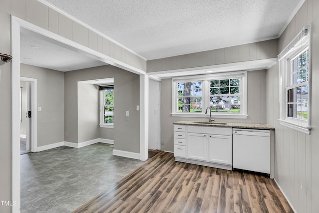 2719 Stratford Dr, Greensboro, NC 27408 - kitchen featuring white dishwasher, a sink, a textured ceiling, white cabinets, and light stone counters