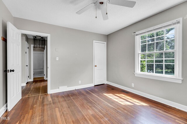 2719 Stratford Dr, Greensboro, NC 27408 - unfurnished bedroom with wood-type flooring, baseboards, and ceiling fan