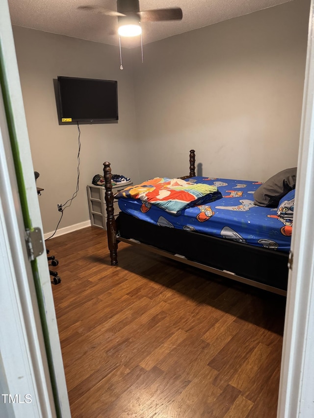 104 Holly Ranch Ct, Willow Springs, NC 27592 - bedroom with wood finished floors, a textured ceiling, and ceiling fan