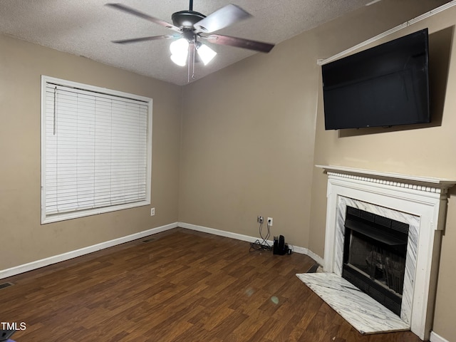104 Holly Ranch Ct, Willow Springs, NC 27592 - unfurnished living room featuring wood finished floors, ceiling fan, a fireplace, and a textured ceiling