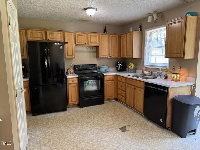 104 Holly Ranch Ct, Willow Springs, NC 27592 - kitchen featuring black appliances, light countertops, a textured ceiling, and light floors