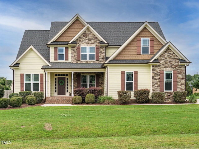 5400 Falconton Ln, Raleigh, NC 27610 - craftsman-style house featuring stone siding, a front yard, and roof with shingles