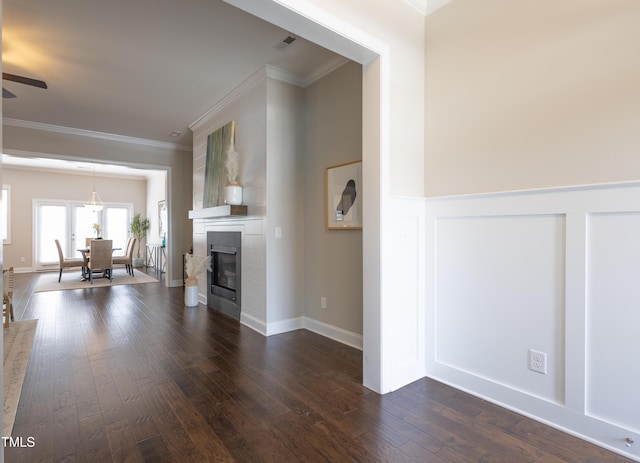 1217 Great Egret Way, Durham, NC 27713 - unfurnished living room featuring crown molding, dark wood-type flooring, a fireplace, and a ceiling fan
