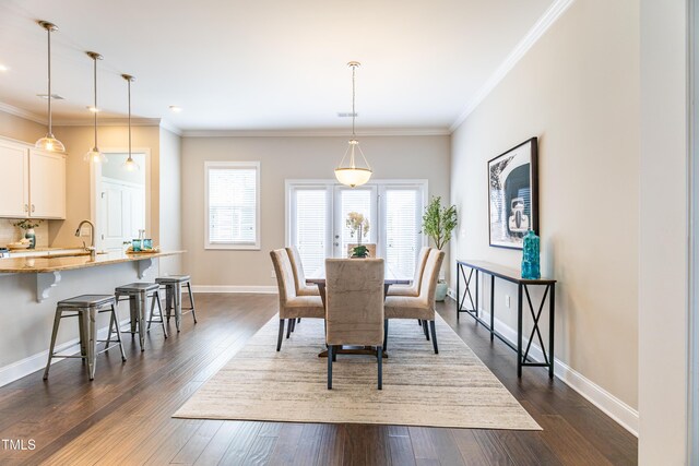 1217 Great Egret Way, Durham, NC 27713 - dining room with ornamental molding, baseboards, and dark wood finished floors