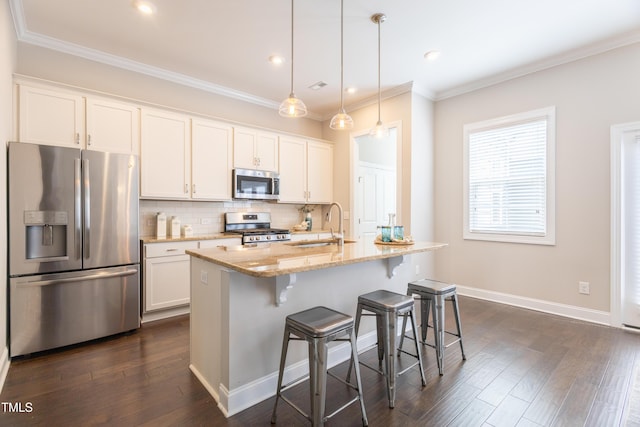 1217 Great Egret Way, Durham, NC 27713 - kitchen featuring stainless steel appliances, a sink, white cabinets, ornamental molding, and recessed lighting