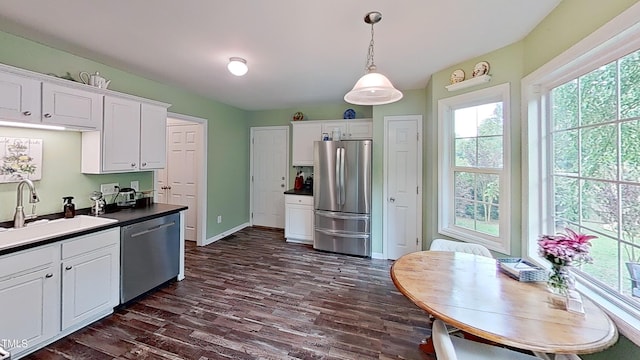 148 Langston Ridge Dr, Angier, NC 27501 - kitchen with stainless steel appliances, a sink, dark countertops, and white cabinetry