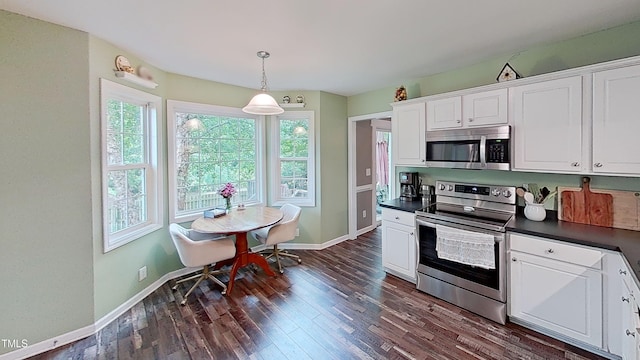 148 Langston Ridge Dr, Angier, NC 27501 - kitchen with appliances with stainless steel finishes, dark countertops, plenty of natural light, and dark wood-type flooring