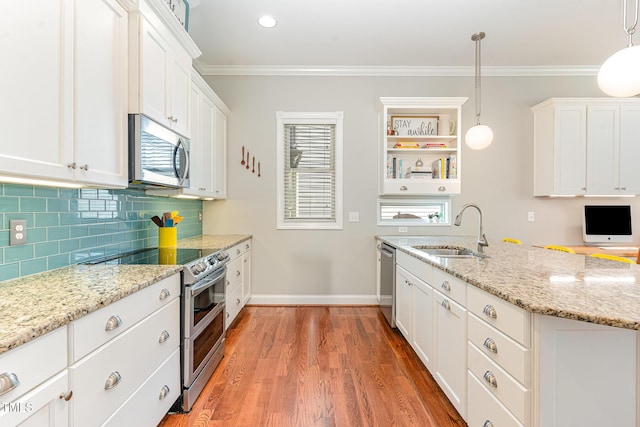 1138 Bexley Hills Bnd, Apex, NC 27502 - kitchen with stainless steel appliances, white cabinetry, light wood-style flooring, backsplash, and ornamental molding
