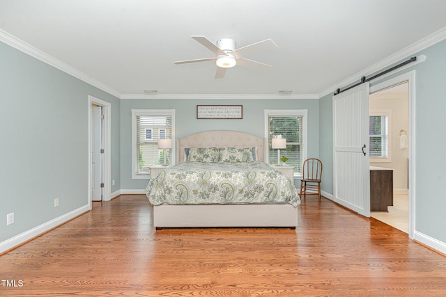 1138 Bexley Hills Bnd, Apex, NC 27502 - bedroom with a barn door, crown molding, wood finished floors, and a ceiling fan