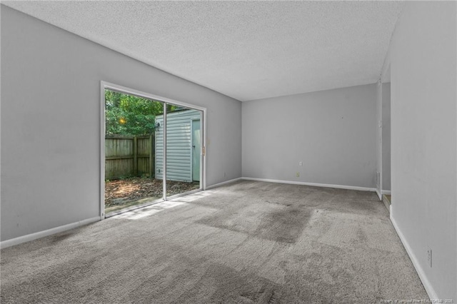 595 Winding Creek Rd Unit C, Fayetteville, NC 28305 - empty room featuring a textured ceiling, carpet floors, and baseboards