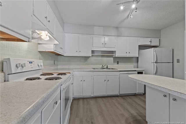 595 Winding Creek Rd Unit C, Fayetteville, NC 28305 - kitchen with white appliances, a sink, a textured ceiling, light countertops, and wood finished floors