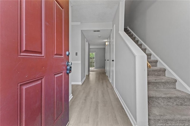 595 Winding Creek Rd Unit C, Fayetteville, NC 28305 - foyer entrance with light wood-style flooring, stairway, a textured ceiling, and baseboards