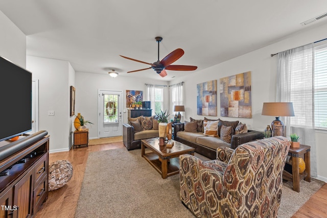 8132 Wheeler Woods Dr, Apex, NC 27539 - living area featuring a ceiling fan, light wood-style flooring, and baseboards