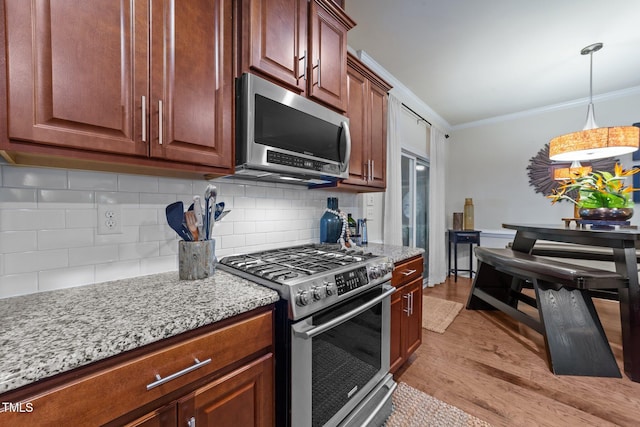 8132 Wheeler Woods Dr, Apex, NC 27539 - kitchen with stainless steel appliances, crown molding, light wood-type flooring, backsplash, and light stone countertops