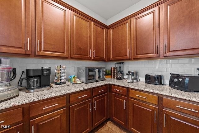 8132 Wheeler Woods Dr, Apex, NC 27539 - kitchen featuring decorative backsplash, light stone counters, and light wood-style floors