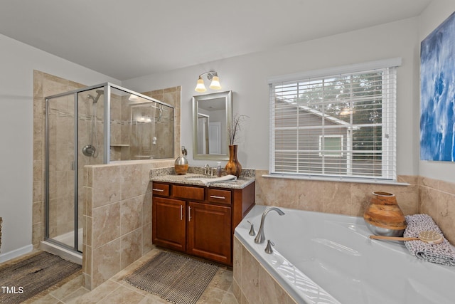 8132 Wheeler Woods Dr, Apex, NC 27539 - bathroom with vanity, a garden tub, a shower stall, and tile patterned floors
