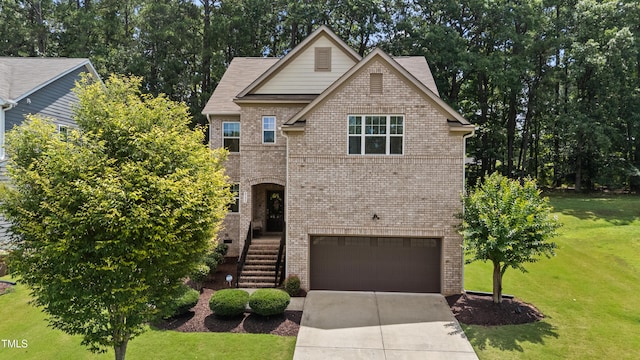 8132 Wheeler Woods Dr, Apex, NC 27539 - view of front facade featuring brick siding, an attached garage, a front lawn, and driveway