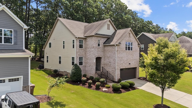 8132 Wheeler Woods Dr, Apex, NC 27539 - view of front of house with brick siding, an attached garage, a front yard, and concrete driveway