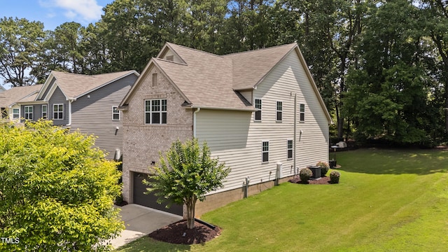 8132 Wheeler Woods Dr, Apex, NC 27539 - view of property exterior with central AC unit, a yard, driveway, a garage, and a shingled roof