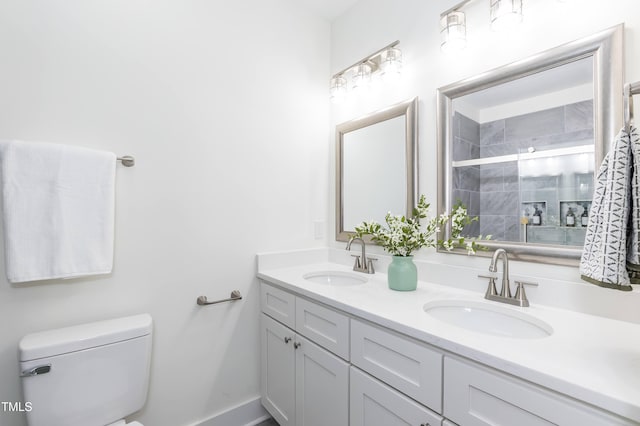 1318 N Alston Ave, Durham, NC 27701 - full bathroom with double vanity, toilet, tiled shower, and baseboards