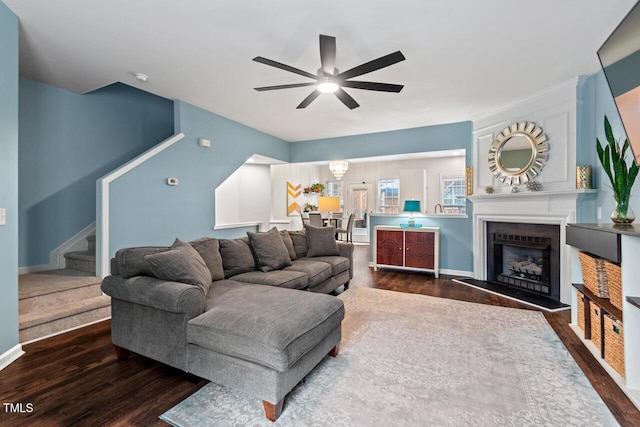 5505 Heather Garden Way, Raleigh, NC 27613 - living area featuring ceiling fan, wood finished floors, stairs, and a fireplace with raised hearth