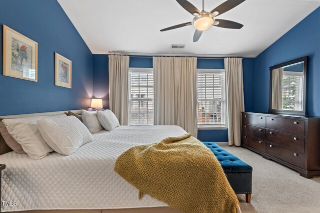 5505 Heather Garden Way, Raleigh, NC 27613 - bedroom with lofted ceiling, multiple windows, light colored carpet, and a ceiling fan