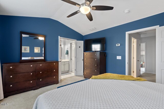 5505 Heather Garden Way, Raleigh, NC 27613 - bedroom with lofted ceiling, light carpet, ceiling fan, and connected bathroom