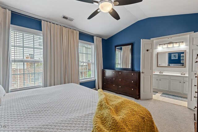 5505 Heather Garden Way, Raleigh, NC 27613 - bedroom with vaulted ceiling, light carpet, connected bathroom, and ceiling fan