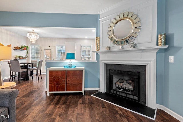 5505 Heather Garden Way, Raleigh, NC 27613 - living room with dark wood-type flooring, a chandelier, and a fireplace with raised hearth