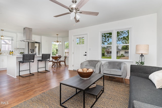 828 Cotton Pl, Raleigh, NC 27601 - living area with a chandelier, wood finished floors, and a ceiling fan