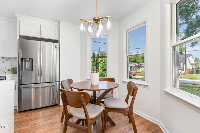 828 Cotton Pl, Raleigh, NC 27601 - dining area featuring healthy amount of natural light, a chandelier, and light wood-style flooring