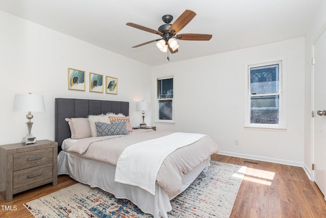 828 Cotton Pl, Raleigh, NC 27601 - bedroom with wood finished floors, baseboards, and a ceiling fan