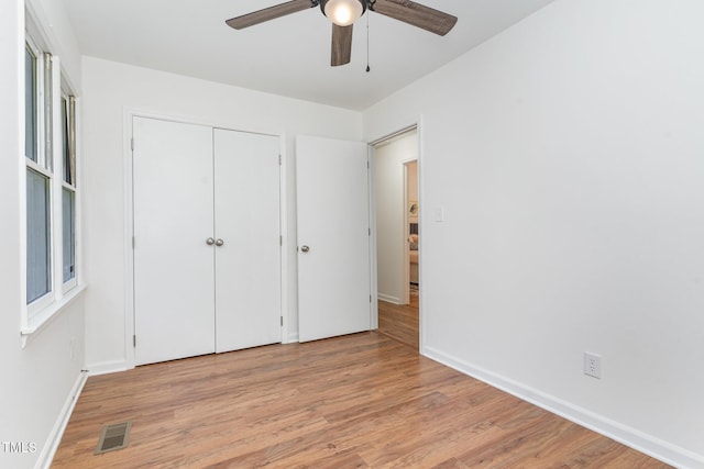 828 Cotton Pl, Raleigh, NC 27601 - unfurnished bedroom with wood finished floors, baseboards, a closet, and a ceiling fan