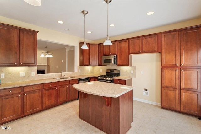 2614 Laurelcherry St, Raleigh, NC 27612 - kitchen featuring appliances with stainless steel finishes, a sink, tasteful backsplash, a kitchen island, and light stone countertops