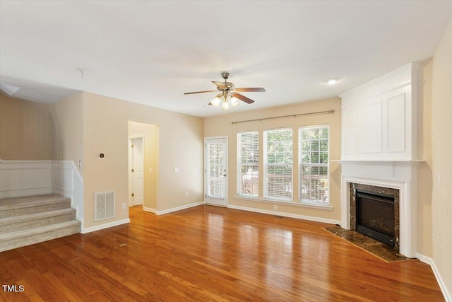 2614 Laurelcherry St, Raleigh, NC 27612 - unfurnished living room featuring a ceiling fan, wood finished floors, a premium fireplace, and stairs