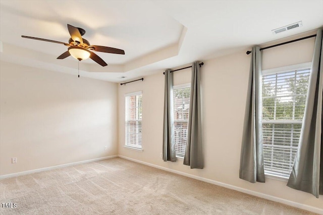 2614 Laurelcherry St, Raleigh, NC 27612 - carpeted spare room featuring a ceiling fan, baseboards, and a tray ceiling