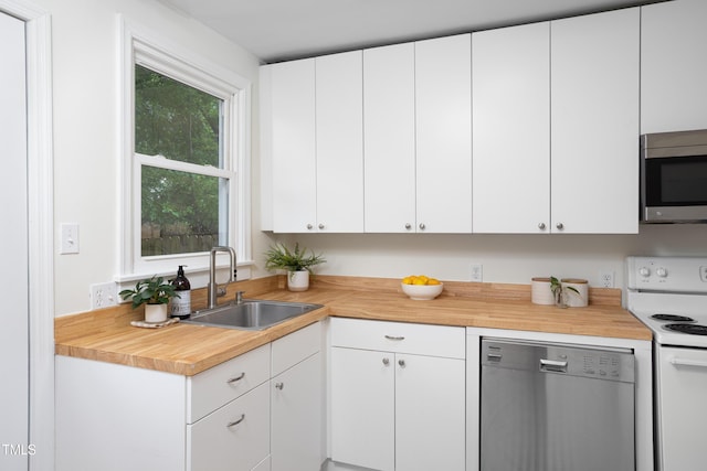 2523 Glendale Ave, Durham, NC 27704 - kitchen with stainless steel appliances, a sink, and white cabinetry