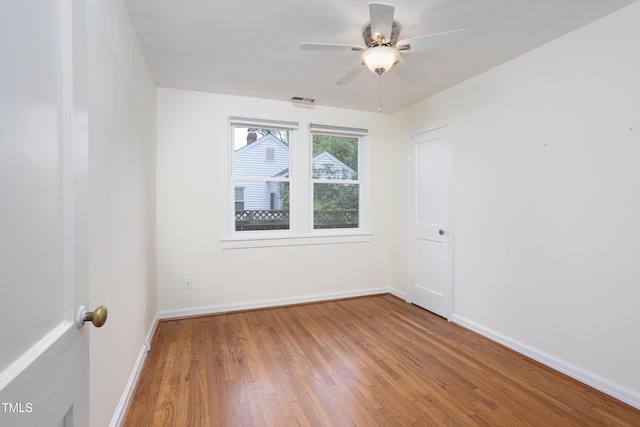 2523 Glendale Ave, Durham, NC 27704 - spare room with wood finished floors, a ceiling fan, and baseboards