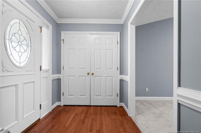 1608 Piney Creek Pl, Fayetteville, NC 28304 - entryway with a textured ceiling, baseboards, ornamental molding, and wood finished floors