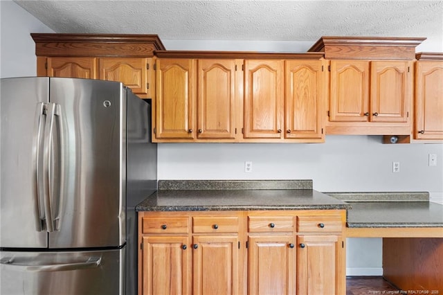 1608 Piney Creek Pl, Fayetteville, NC 28304 - kitchen with freestanding refrigerator, dark countertops, and a textured ceiling