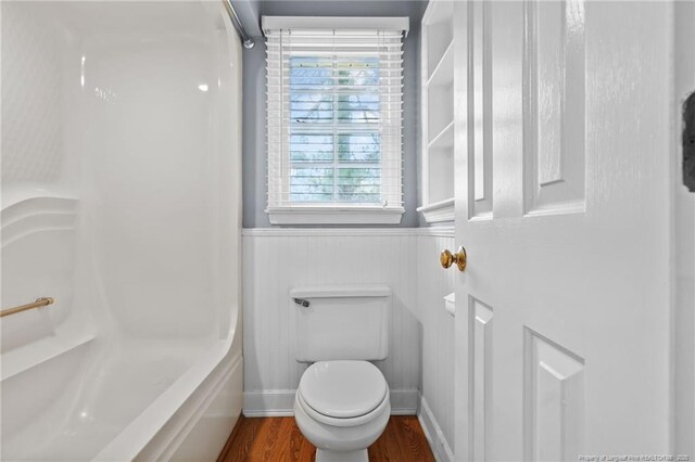 1608 Piney Creek Pl, Fayetteville, NC 28304 - full bathroom with wainscoting, wood finished floors, toilet, and bathing tub / shower combination