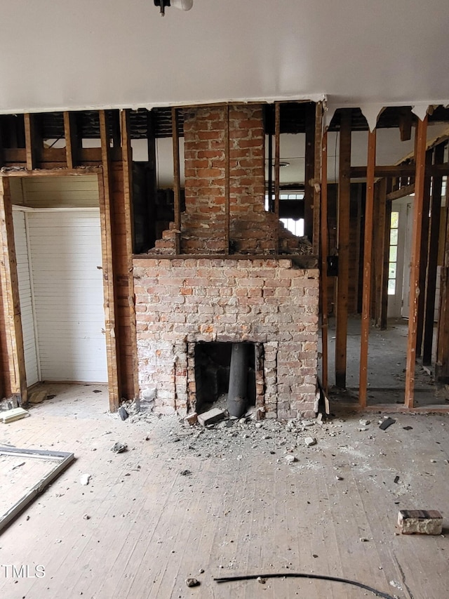 431 Charles St, Henderson, NC 27536 - unfurnished living room with an outdoor brick fireplace and wood-type flooring