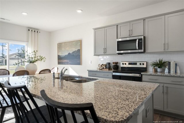 233 Hartfield Ave, Raeford, NC 28376 - kitchen featuring stainless steel appliances, gray cabinets, a sink, a center island with sink, and recessed lighting