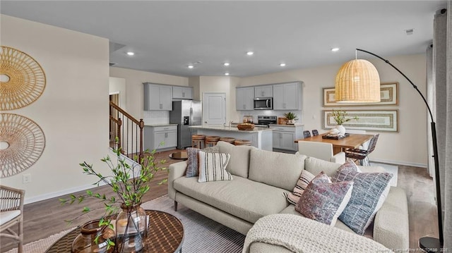 233 Hartfield Ave, Raeford, NC 28376 - living area featuring baseboards, light wood-style floors, stairs, and recessed lighting
