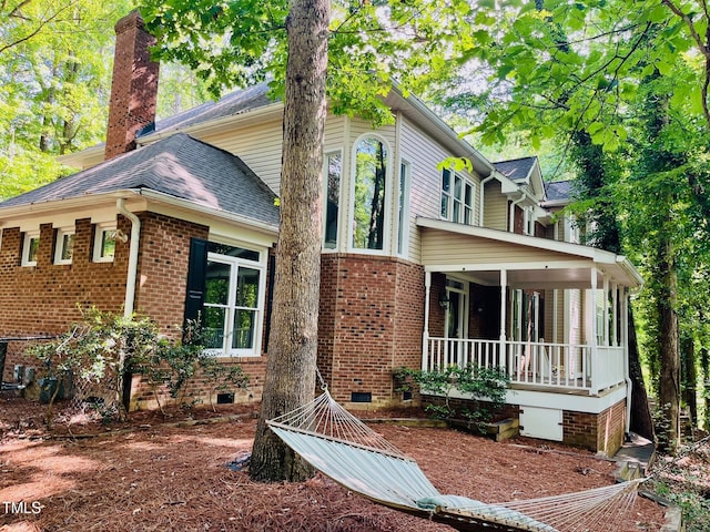 1512 Cumberland Rd, Chapel Hill, NC 27514 - view of front of home featuring brick siding, a chimney, crawl space, and roof with shingles