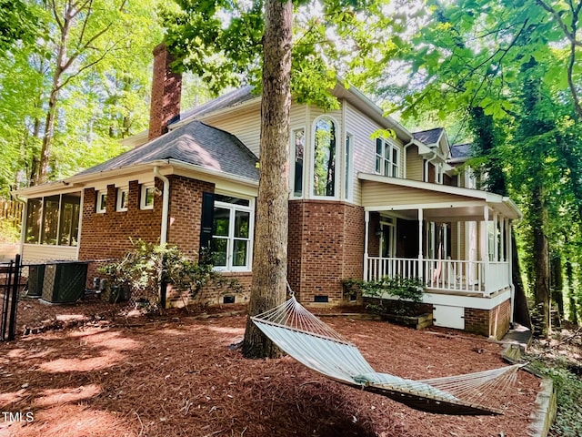 1512 Cumberland Rd, Chapel Hill, NC 27514 - view of front of home with crawl space, a sunroom, a chimney, brick siding, and cooling unit