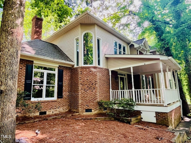 1512 Cumberland Rd, Chapel Hill, NC 27514 - view of front of home featuring covered porch, crawl space, brick siding, a chimney, and a shingled roof