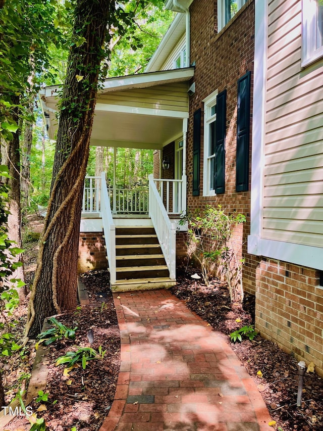 1512 Cumberland Rd, Chapel Hill, NC 27514 - view of exterior entry with a porch and brick siding